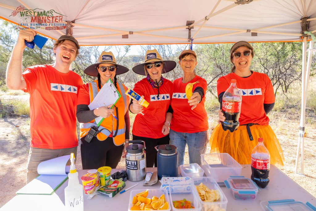 Group celebrating outdoors with snacks and drinks.